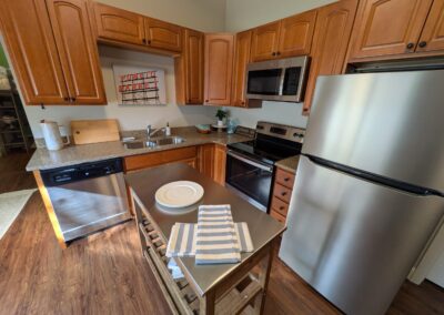 Modern kitchen with wooden cabinets and stainless steel appliances.